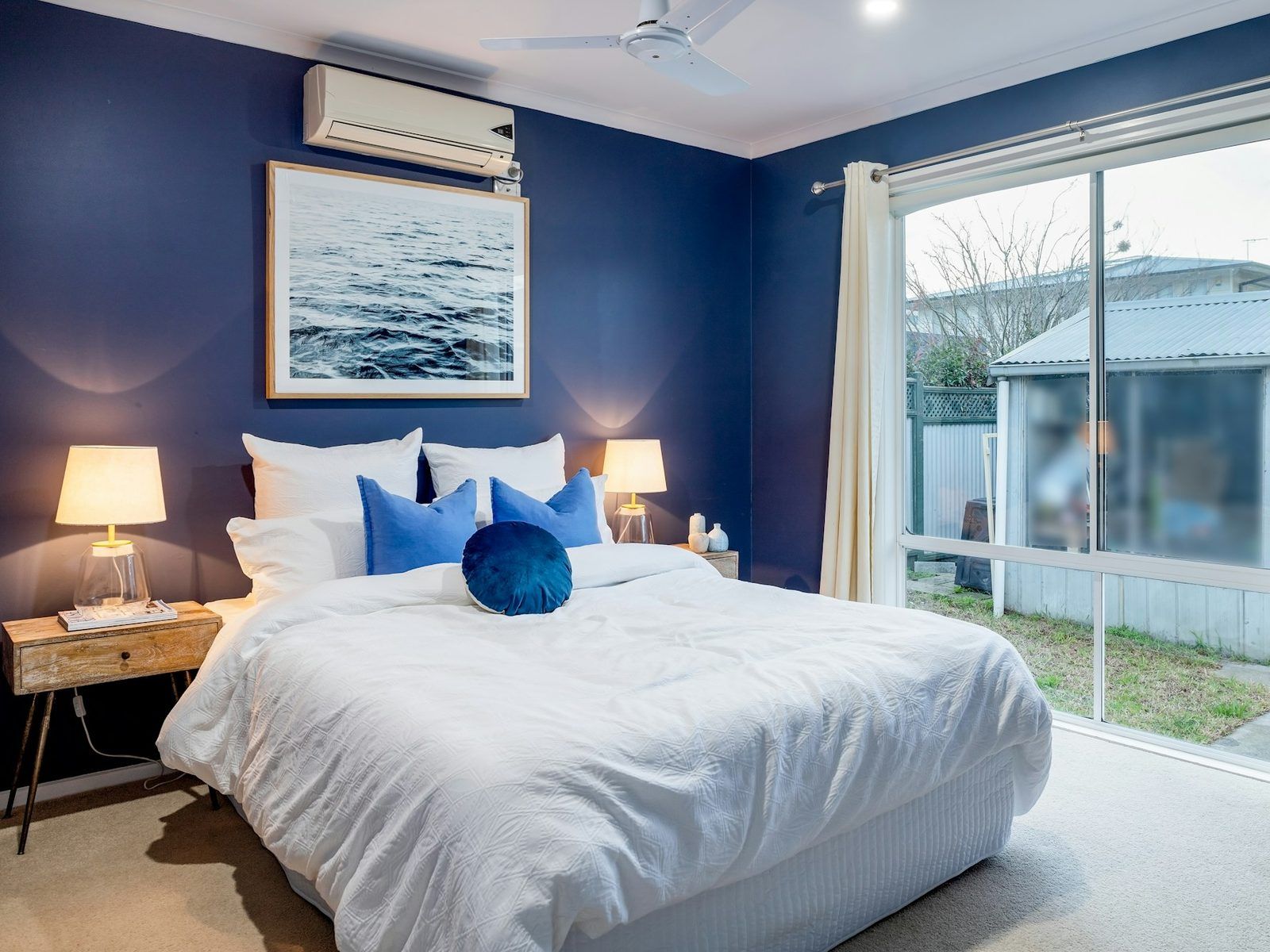 Bedroom with an air conditioner above the bed